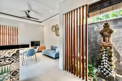 a living room with a blue couch and a table at Exclusive 2BR Villa with bathroom en suite and privat Pool in Kerobokan