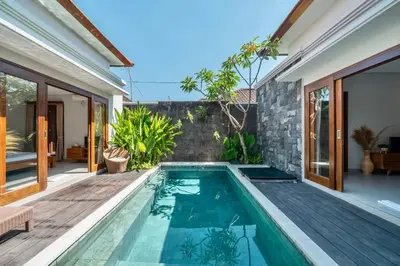 an infinity pool in a villa with a house at Exclusive 2BR Villa with bathroom en suite and privat Pool in Kerobokan