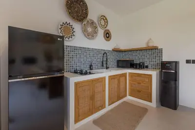 a kitchen with a sink and a refrigerator at Seminyak Dream 1 bedroom villa with private pool in Seminyak