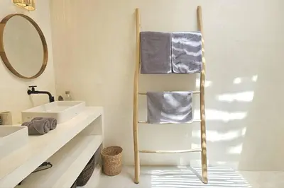 a bathroom with a towel rack with a sink and a mirror at Seminyak Dream 1 bedroom villa with private pool in Seminyak