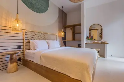 a bedroom with a bed and a table and a mirror at Seminyak Dream 1 bedroom villa with private pool in Seminyak