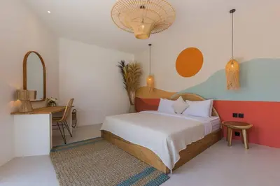 a bedroom with a bed and a table and a desk at Villa Alamanda Maya Seminyak center 2 bedr with private Pool in Seminyak