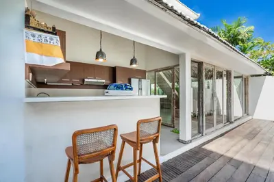 a kitchen with two chairs and a counter at Villa Oberoi in Seminyak