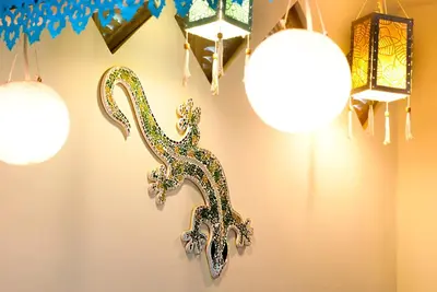 a group of chandaliers hanging on a wall with lights at Villa Domus Dua in Seminyak