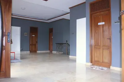 a room with blue walls and wooden doors at Aiwan Hostel & Luggage storage in Sanur