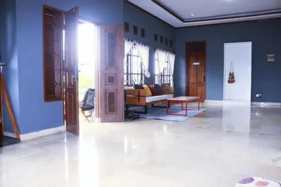 a living room with blue walls and a couch at Aiwan Hostel & Luggage storage in Sanur