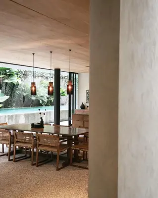a dining room with a table and chairs at Sandhouse Berawa in Canggu