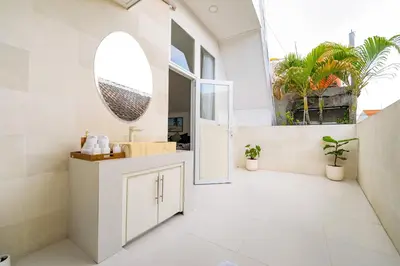 a bathroom with a mirror on the wall and a sink at Spacious 3 BR Villa with private pool and Billiards in Seminyak