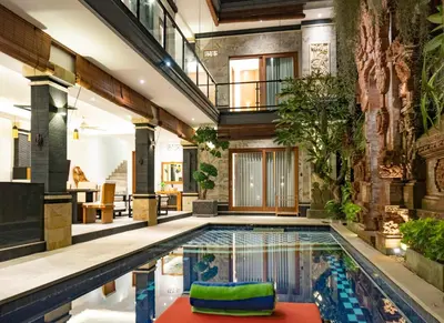 an indoor pool in a house with a house at Winy Estate - Luxury Villa with Rooftop Jacuzzi in Canggu