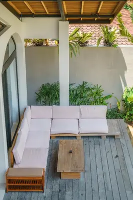 a white couch on a patio with a coffee table at Casa Donilo - 4BR Designer Villa in Canggu in Canggu