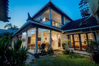 a house with large windows and a patio at Sari Temuku Villa in Seminyak