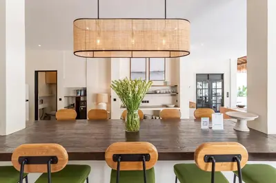 a dining room with a large wooden table and chairs at Villa Jodoh - Exciting Chic 4BR Stylish Villa Near Seminyak, Perfect for a Trendy Getaway in Kerobokan
