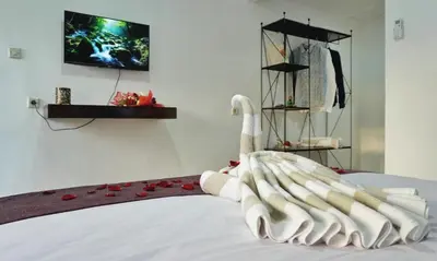 a swan made out of towels on a bed at Balian Surf Club in Legian