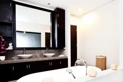 a bathroom with two sinks and a large mirror at Villa Penelopy in Seminyak