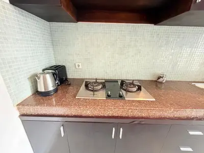 a kitchen counter top with a stove top oven at Villa Penelopy in Seminyak