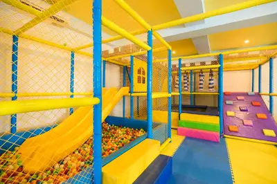 an indoor play room with a slide and a climbing gym at Grand Mirage Resort & Thalasso Bali - All Inclusive in Nusa Dua