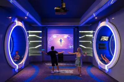 a man and a woman standing in front of a room with two mirrors at Grand Mirage Resort & Thalasso Bali - All Inclusive in Nusa Dua