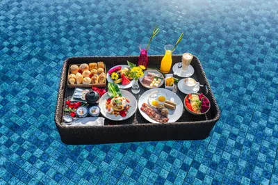 a tray of food on a table with food at Grand Mirage Resort & Thalasso Bali - All Inclusive in Nusa Dua