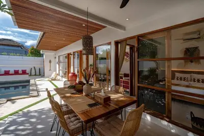 a dining room with a wooden table and chairs at Cosy 2bd Chic Villa with Private Pool in Central Location in Kerobokan