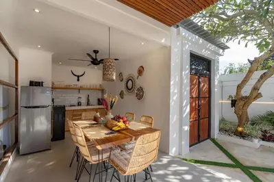 a kitchen and dining room with a table and chairs at Cosy 2bd Chic Villa with Private Pool in Central Location in Kerobokan