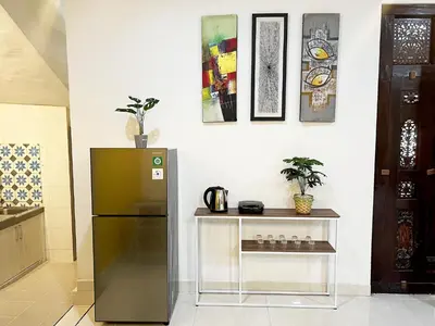 a kitchen with a refrigerator and a table at Villaok in Kuta