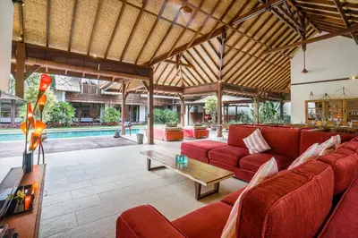 a living room with red couches and a pool at Villa Cira - 5 Bedrooms Private Villa Next to Seminyak in Seminyak
