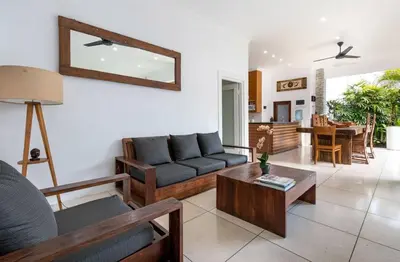 a living room with a couch and a table at Buddha Beach Villa Seminyak in Seminyak