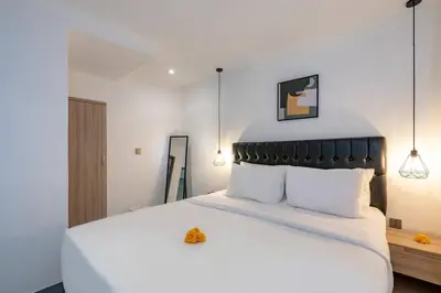 a bedroom with a large white bed with white pillows at Central 3bd Modern Villa with Private Pool and Play Area in Kerobokan