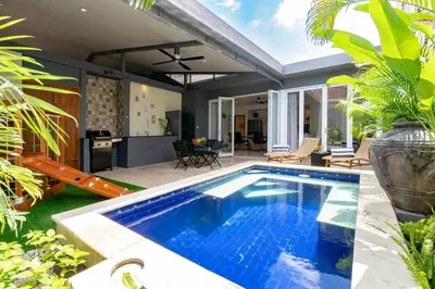 a swimming pool in the backyard of a house at Central 3bd Modern Villa with Private Pool and Play Area in Kerobokan