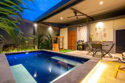 a swimming pool in the middle of a house at Central 3bd Modern Villa with Private Pool and Play Area in Kerobokan