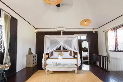 a bedroom with a bed with a canopy at Private villa with pool near 66 in Seminyak in Seminyak