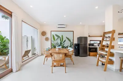 a kitchen and dining room with a table and chairs at Roselle Villa by Betterplace in Canggu