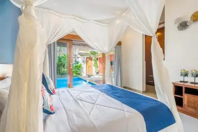 a bedroom with a bed with a canopy at New Villa Lotus 2BR Private Pool Villas in Seminyak