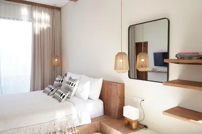 a bedroom with a bed and a large mirror at VILLA HAWILA 2BR OBEROI SEMINYAK PRIME LOCATION - No FLOOD in Seminyak