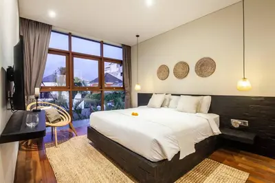 a bedroom with a large bed and a large window at Luxury 3bd Villa 5 Min From Berawa Beach in Canggu