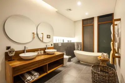a bathroom with two sinks and a tub and mirror at Luxury 3bd Villa 5 Min From Berawa Beach in Canggu