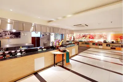 a large kitchen with wooden counters and a counter top at HARRIS Hotel Seminyak in Seminyak