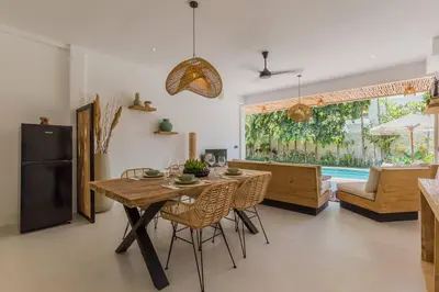 a kitchen and dining room with a table and chairs at Villa Alamanda Livia Seminyak Design spacious 2bdr and private pool in Seminyak