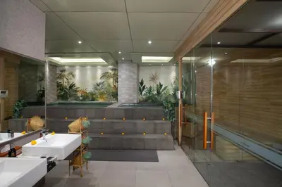 a bathroom with two sinks and some plants at Platinum Hotel Jimbaran Beach Bali in Jimbaran