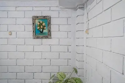 a picture of flowers on a white brick wall at Ammara Legian By Vilarisi - 8 Minute Walk To The Beach in Legian