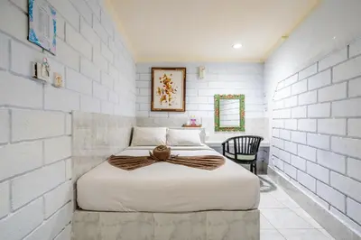 a bedroom with a bed with a bow on it at Ammara Legian By Vilarisi - 8 Minute Walk To The Beach in Legian