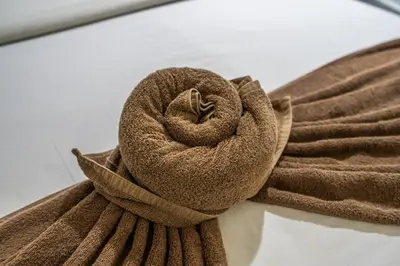 a brown towel sitting on top of a table at Ammara Legian By Vilarisi - 8 Minute Walk To The Beach in Legian