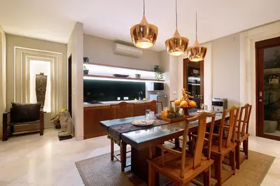 a kitchen and dining room with a table and chairs at Villa Giva Seminyak - 2 Bedrooms Seminyak in Seminyak