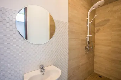 a bathroom with a sink and a mirror at Berawa Bali Beach Villas Canggu in Canggu