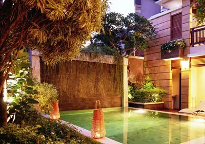 a swimming pool in the middle of a garden at Dreamscape Bali Villas Canggu in Canggu