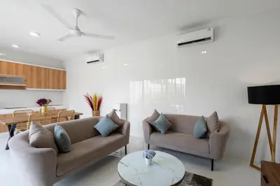 a living room with two couches and a table at Serenity Villa by Betterplace in Kerobokan