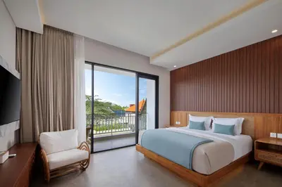 a bedroom with a bed and a large window at Sayang Villa Bali in Kerobokan