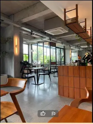 a dining room with tables and chairs and windows at LBV Ambengan Tenten in Denpasar