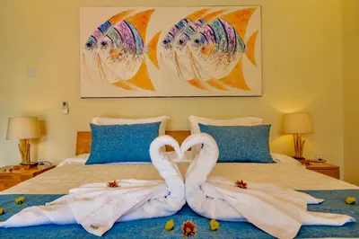 two towel swans making a heart on a bed at Villa Domino - *NEW* Luxurious 2BR w/ Pool @Central Seminyak in Seminyak