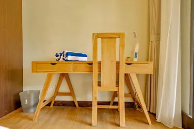 a wooden desk with a mirror and a table at Villa Domino - *NEW* Luxurious 2BR w/ Pool @Central Seminyak in Seminyak